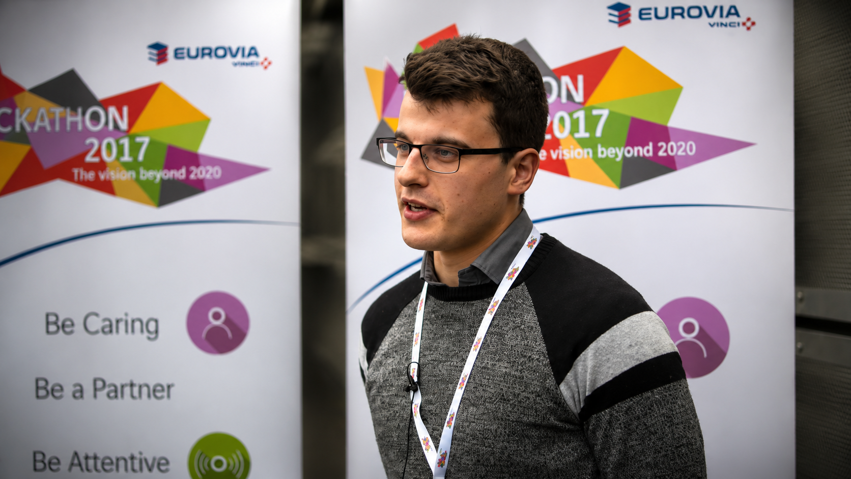 Eurovia employee interview in front of the Hackathon 2017 branded backdrop