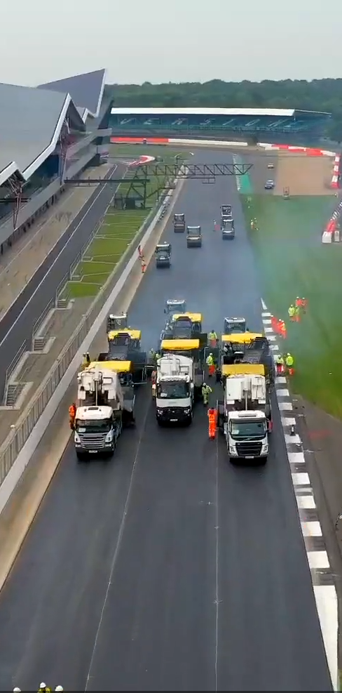 Aerial drone view of Tarmac's resurfacing convoy on the Silverstone start-finish straight