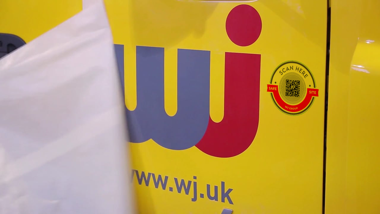 Close-up of the WJ Group brand on a specialist road-marking vehicle with the WJ SafeSite QR code